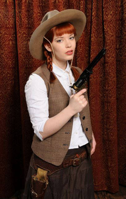Western girl with big gun at PokerGirl Strip Poker